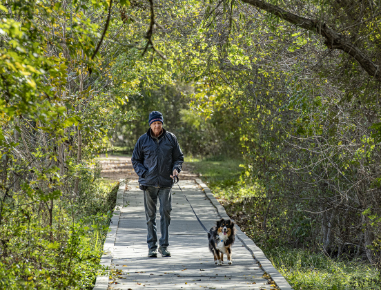 Doug Martin and his dog, Toby, enjoy the morning scenery during a walk together.
