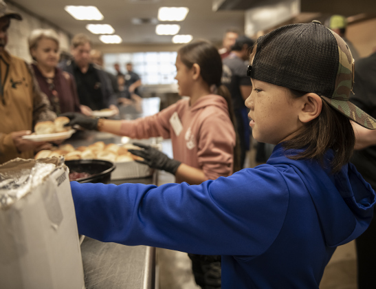 Logan Toomgem, 8, helped distribute meals.  The event was coordinated by Alycia Tandy, founder of AnTandy Boutique, with help from many volunteers in the Georgetown community.