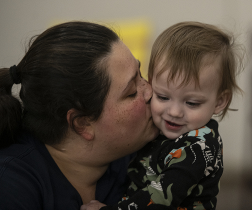 Kamry Salyer cuddles with her son Alexander, 14-months-old, after feeding him some Thanksgiving treats.