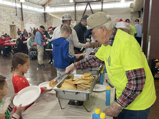 Rotary members serve guests a hearty Santa breakfast of pancakes and sausage December 17. Breakfast proceeds serve area youth programs. (Courtesy Georgetown ISD)