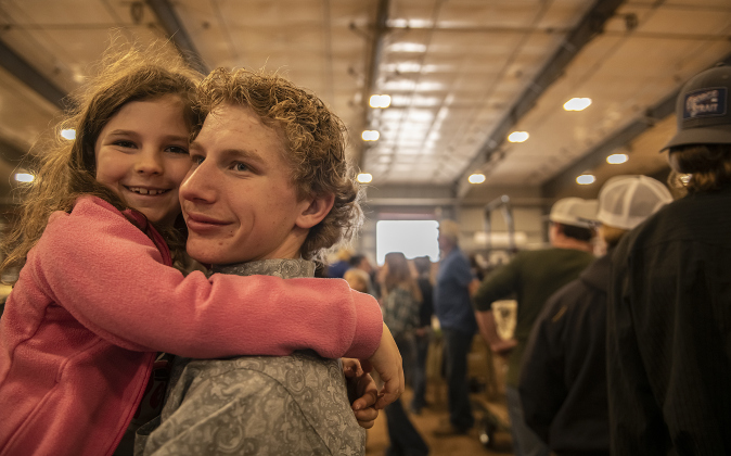 Dayton Knippa, 14, a member of the Georgetown 4-H Club, spends time with his cousin Brynn Raesz, 7, after winning awards in poultry judging.