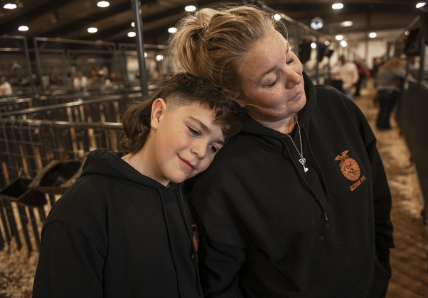 Coleton Wiemers, 12, with the Glenn High School FFA program, with his mom Heather Wiemers the opening day of the Williamson County Livestock Show. Coleton is showing both goats and pigs this year.