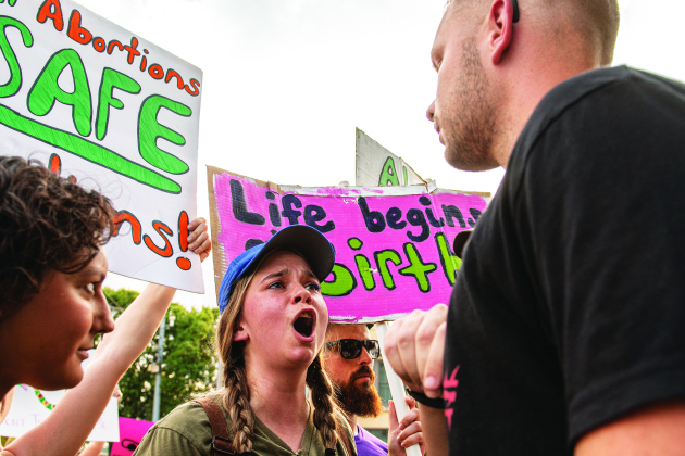 Abortion rights advocate Britt Donohoo, facing camera, argues her view with John (first name only given), a member of Georgetown's Covenant Bible Church during an abortion rights demonstration held at the square  on Sunday, July 10. (Photos by Andy Sharp)