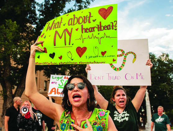 Abortion rights advocates Andrea Price, front left, and Ashleigh Banks, back right, make their points with their posters  during an abortion rights demonstration held at the square  on Sunday, July 10.