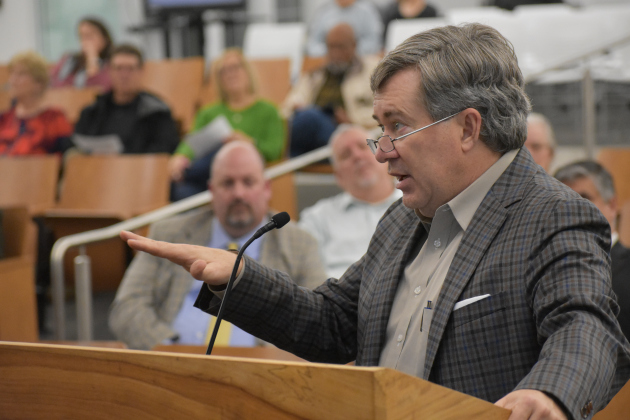 Demographer Bob Templeton spells out how high interest rates are slowing home sales during Georgetown ISD’s Monday, December 12, board meeting.  (Photo by Katherine Anthony)
