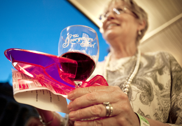 Carolyn Steenken of Georgetown holds onto her souvenir wine glass as she makes her way around the square during the 2016 Georgetown Swirl. (Sun Archive)
