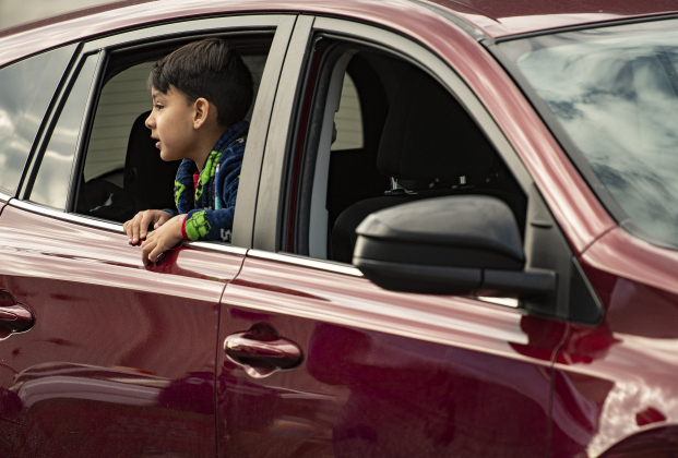 Samuel Blanco, 5, waits with his family to receive their gift boxes.