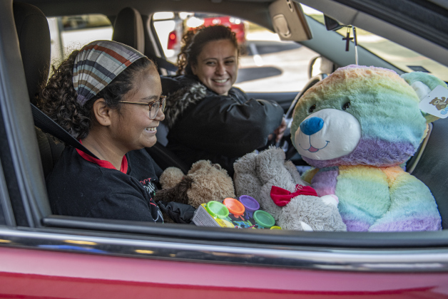 10-year-old Ayva Pereira and her mom Sonia Pereira were very happy with their gift boxes and big stuffed animals during the Georgetown Police Department's Blue Santa distribution, held at the Georgetown Public Safety headquarters on Saturday, December 17.   Volunteers gave out gift boxes for 2235 children and over 700 pre-qualified  families this year.  Georgetown's Blue Santa program began in 2005. (Photo by Andy Sharp)