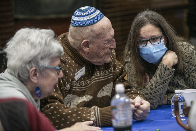 Robert Baer, center,  and his wife Linda, left, chat with Leila Liberman during a Sun City gathering of Congregation Havurah Shalom on Sunday, December 18, the first night of Hanukkah. (Photos by Andy Sharp)