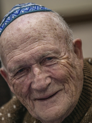 Robert Baer, with  Congregation Havurah Shalom, visits with friends in Sun City during the first night of Hanukkah on Sunday, December 18.