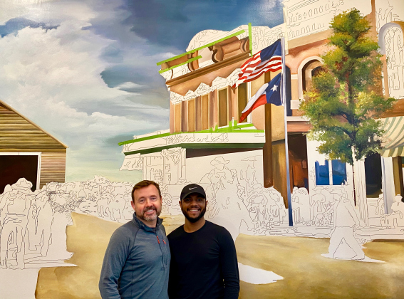 The new, colorful mural at City Post Chophouse is in the works, paying special homage to the cowboy days of the Chisholm Trail and long ago First Mondays in Georgetown. Kevin Cummins (City Post owner) and Devon Clarkson (muralist) agree the mural will be completed next week.