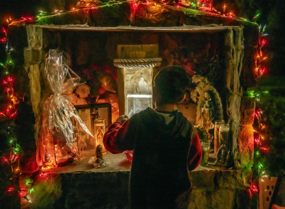 4-year-old Reign Cruz is shown on Tuesday, December 20, as he stands by a tribute honoring  his mother, Alexandra Chavarria.