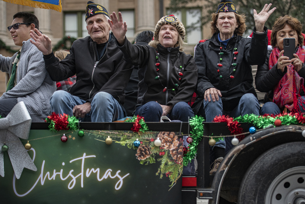 Members of American Legion Post 174 ride a float in.