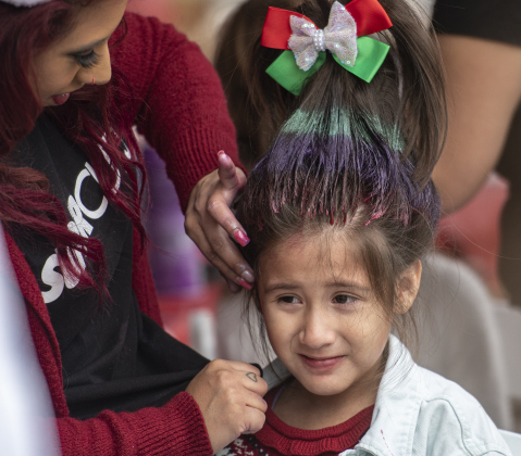 Stylist Autumn Alferos from Supercuts gives 5-year-old Maddie Castillo a Whoville hairdo.