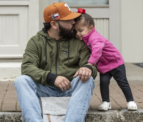 Jeremy Garcia spends quiet time along Eighth Street with his 18-month-old daughte, Sienna.