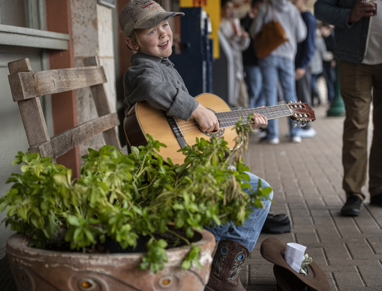 Max Fomichev, 7, played his guitar along Main Street for attendees at Georgetown's Christmas Stroll on Saturday, December 3.  Max was getting plenty of tips in his hat, which dad says he's saving to buy a dirt bike.