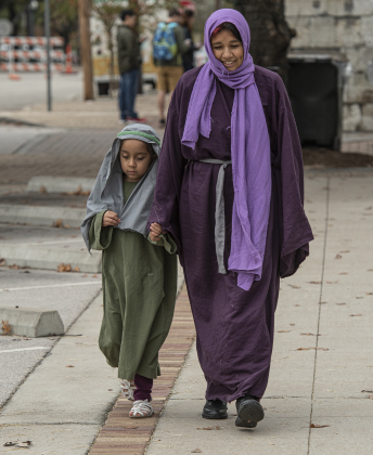 Abigail Ramirez, 6, takes a walk along Ninth Street with her sister, Genesis Ramirez, 16. They were participants in Bethlehem Village, presented by Georgetown Church of the Nazarene.