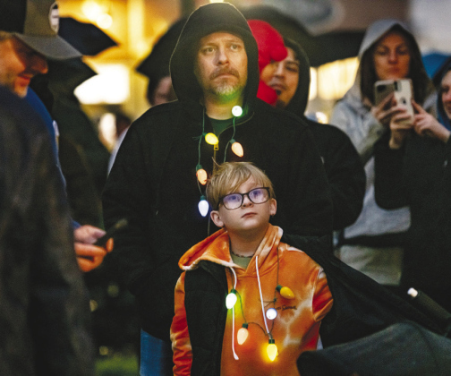 Ty Lucero and his son Wyatt, 9, wear matching colorful lights.