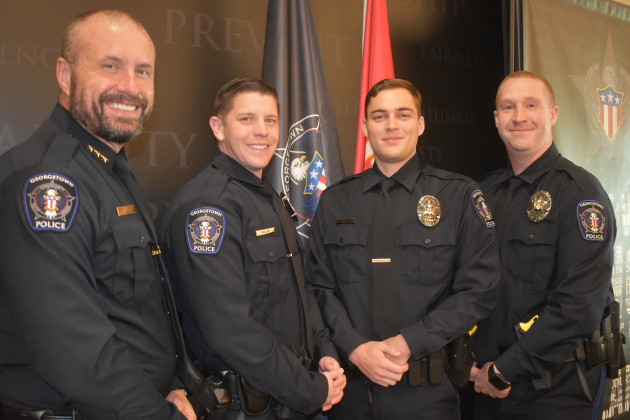 Georgetown Police Department Chief Cory Tchida, left, congratulates new officers sworn in Thursday. From left, they are Caleb Miller, Dakota Norwood and Dylan Wright.