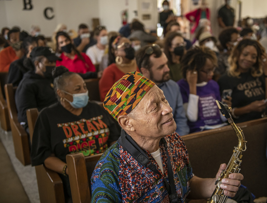Musician Ruffie London played his alto saxophone during service at Macedonia Baptist Church following the march.