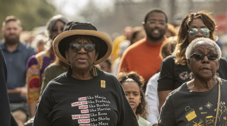Paulette Taylor, left, and Ella Moorer, right, take part in the Dr. Martin Luther King Jr. holiday celebration march from the square.
