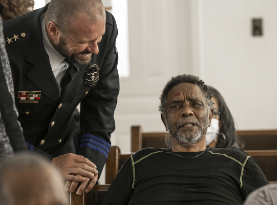 Georgetown Police Chief Cory Tchida, left, checks on Cliff Brown after Mr. Brown fell during the march from the square. Mr. Brown was helped up by other marchers and was able to continue his walk to Macedonia Baptist Church.