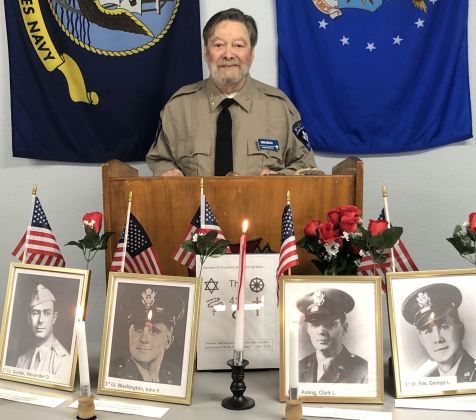 Post Chaplain Michael Meccia opens the Four Chaplains Memorial Service held January 21. On the table in front of the podium are photos of the four chaplains being remembered, Lieutenants George L. Fox, Alexander D. Goode, John P. Washington and Clark V. Poling. 