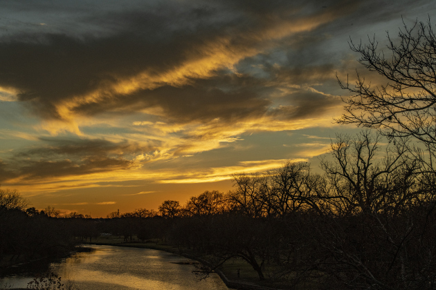 Skies fill with color over the San Gabriel River at San Gabriel Park on New Years Eve, Saturday, December 31, 2022.