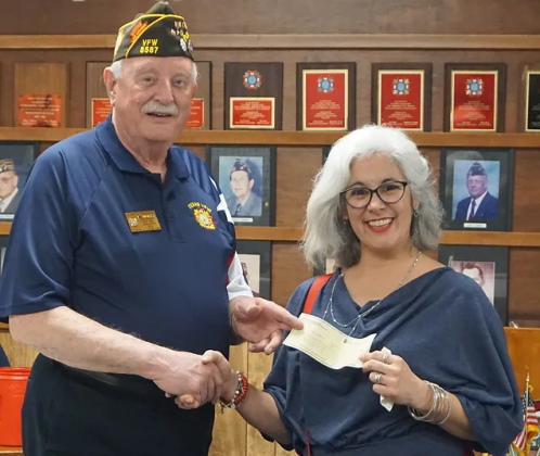 VFW Post 8587 Commander Don Willhouse presents Teacher of the Year winner Stephanie A. Fejeran with her check. Ms. Fejeran teaches kindergarten through fifth grade at St. Helen’s Catholic Church.