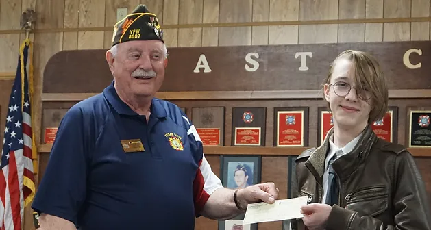 Post Commander Don Willhouse presents Wyatt Handy, winner of the Voice of Democracy Competition, with his check. Wyatt also won the competition at the District 28 level and will receive another check in the near future.