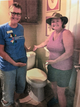 Group members install a toilet at a house that needed repairs. This is one of many tasks Georgetown Helpers is capable of completing. (Courtesy  Georgetown Helpers)
