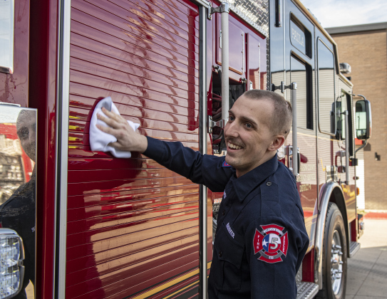 Jarrell firefighter Jake Owen helps with a ceremonial cleaning of his department's new ladder truck February 17. Mr. Owen, 24, is undergoing treatment for brain cancer and had returned to the department for the first time since starting treatments in January. Photo by Andy Sharp 