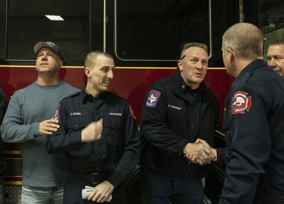 Jarrell firefighter Jake Owen, second from left, is shown with his father, Georgetown firefighter Craig Owen, left, and Georgetown Fire Department Battalion Chief Carl Boatright, facing camera at right, shaking hands with Jarrell Fire Chief Ron Stewart, right, as the Jarrell Fire Department’s new ladder truck is presented.