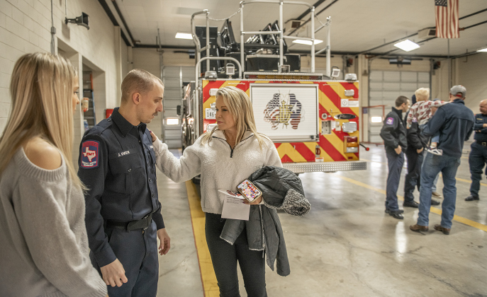 Jarrell firefighter Jake Owen spends time with his sister, Bailey, left, and their mom, Teresa Owen, right, at  the presentation of  his department's new ladder truck during a ceremony held at Jarrell Station 2 on Friday, February 17. Photo by Andy Sharp.