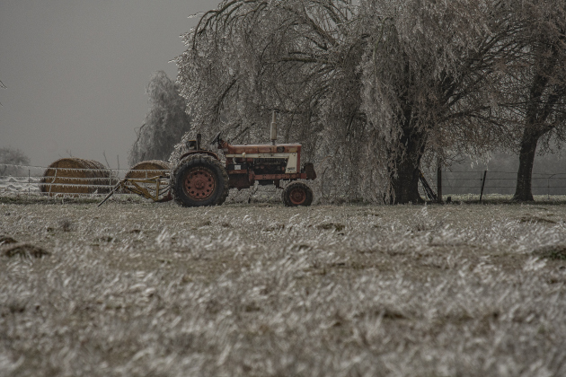 An old tractor and hay  sit dormant in an ice-covered field along County Road 409 on Wednesday, February 1.