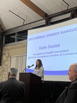 Board Chair Karin Sladek gives a speech before the next award is given.