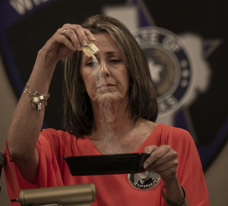 Becky Stewart, a Williamson County mom who lost her son Cameron, 19, to fentanyl poisoning, uses a packet of artificial sweetener to demonstrate how such a small amount can kill several people. She spoke at a sheriff's event at the Williamson County Expo Center on Tuesday, March 7. Photos by Andy Sharp
