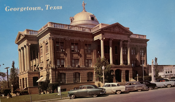 A colorized photo of the courthouse from the last 1950s. The original architecture elements along the top were still in place but removed in the 1960s.