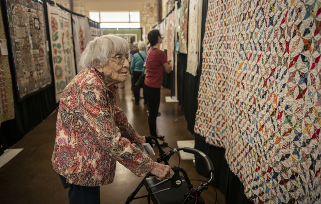 JoAnn Hammer admires a quilt made in 1940 entitled "Starry Night"  on Saturday, March 25, at the annual Georgetown Quilt Show, presented by Handcrafts Unlimited.