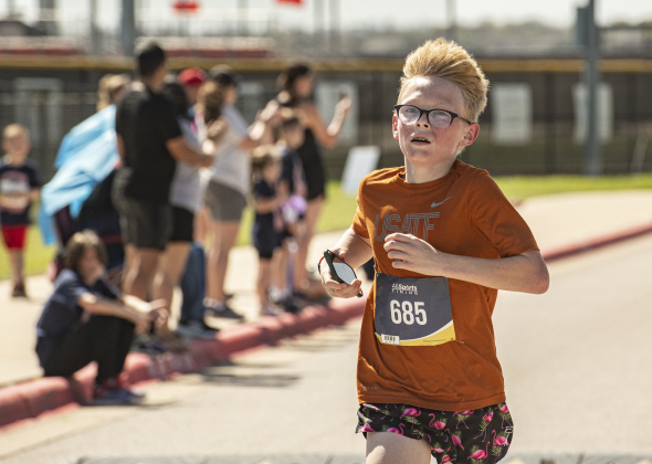 13-year-old Kingston Wilson, an 8th grader at Wagner Middle School, nears the finish line to finish first in the 5-K Race during  Chase the Chief, held at East View High School on Sunday, March 5.