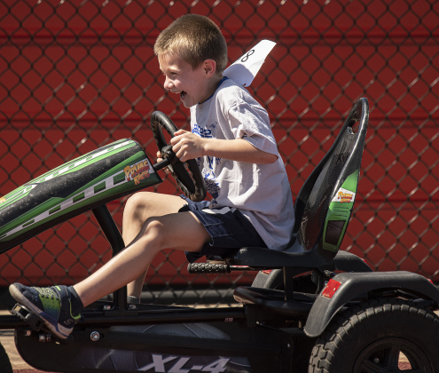 6-year-old  Aaron Davis makes fast time navigating a pedal cart during  the Chase the Chief Fitness Challenge.