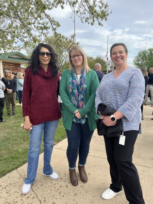 Harriet Jones, Amanda Remster and Kimberly Nesmith stand in support.