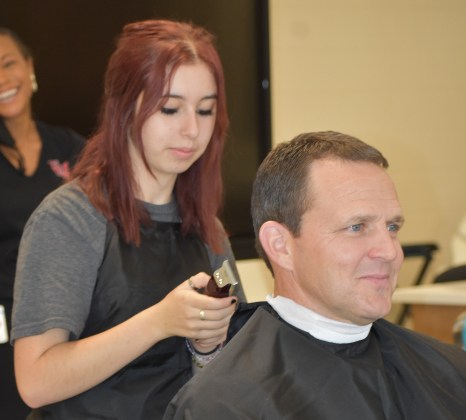 Georgetown ISD superintendent Fred Brent gets a haircut in October 2021 at the East View High School cosmetology lab. The facility was named after Sport Clips founder Gordon Logan and his family in recognition of their financial support for the program.  Photo by Katherine Anthony