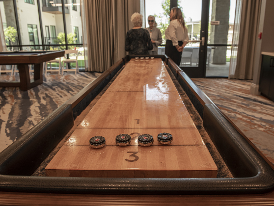 Residents and guests visit the game room. The facility includes a fitness center, game room, screening room, a lounge, plus a large outdoor swimming pool and performance pavilion, plus Alma, a Stephan Pyles restaurant which will be open to the public when it opens in May.