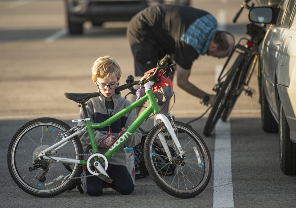 8-year-old Sebastian Quindlen and his dad Kevin Quindlen get their bikes ready to participate.