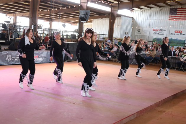 Sun City Cloggers fill the dance floor for a special performance.