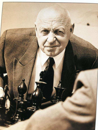 As an older man, Howard Bleeke played cranky old men and elegant old men. In this photo, he is shown as a participant in a chess game.