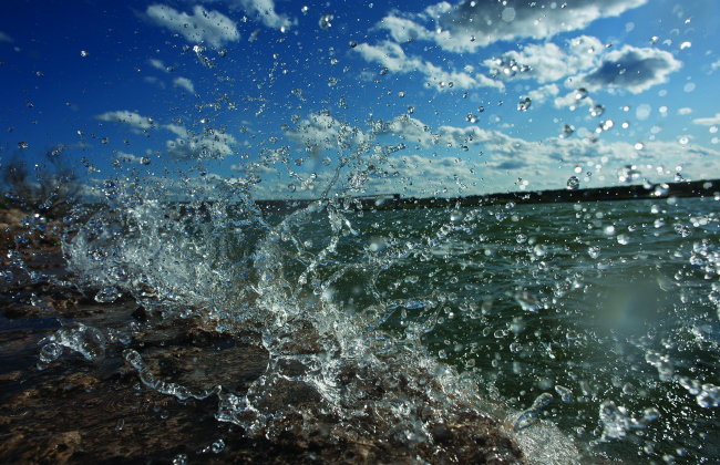 Lake Georgetown is shown as waves of water pound the shoreline.  