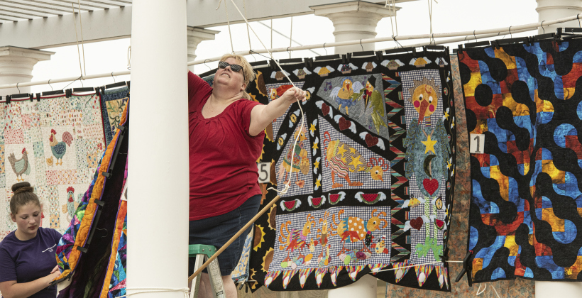 Sophia Rae, left, and Michelle Brown, with the Blackland Quilting Guild, display some of the group's work during Blackland Prairie Days, held at Heritage Square Park on Saturday.