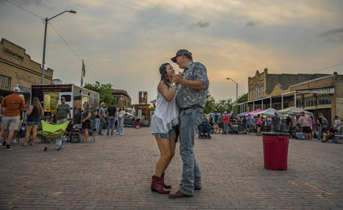 Emily Holmes enjoys a dance with Darren Mogonye along West Davilla Street (closed to traffic) during the second night of Granger's Lakefest on Friday, May 12, 2023.